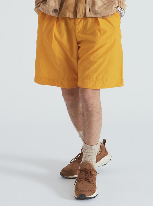 Universal Works Pleated Track Short In Orange Recycled Nylon Tech