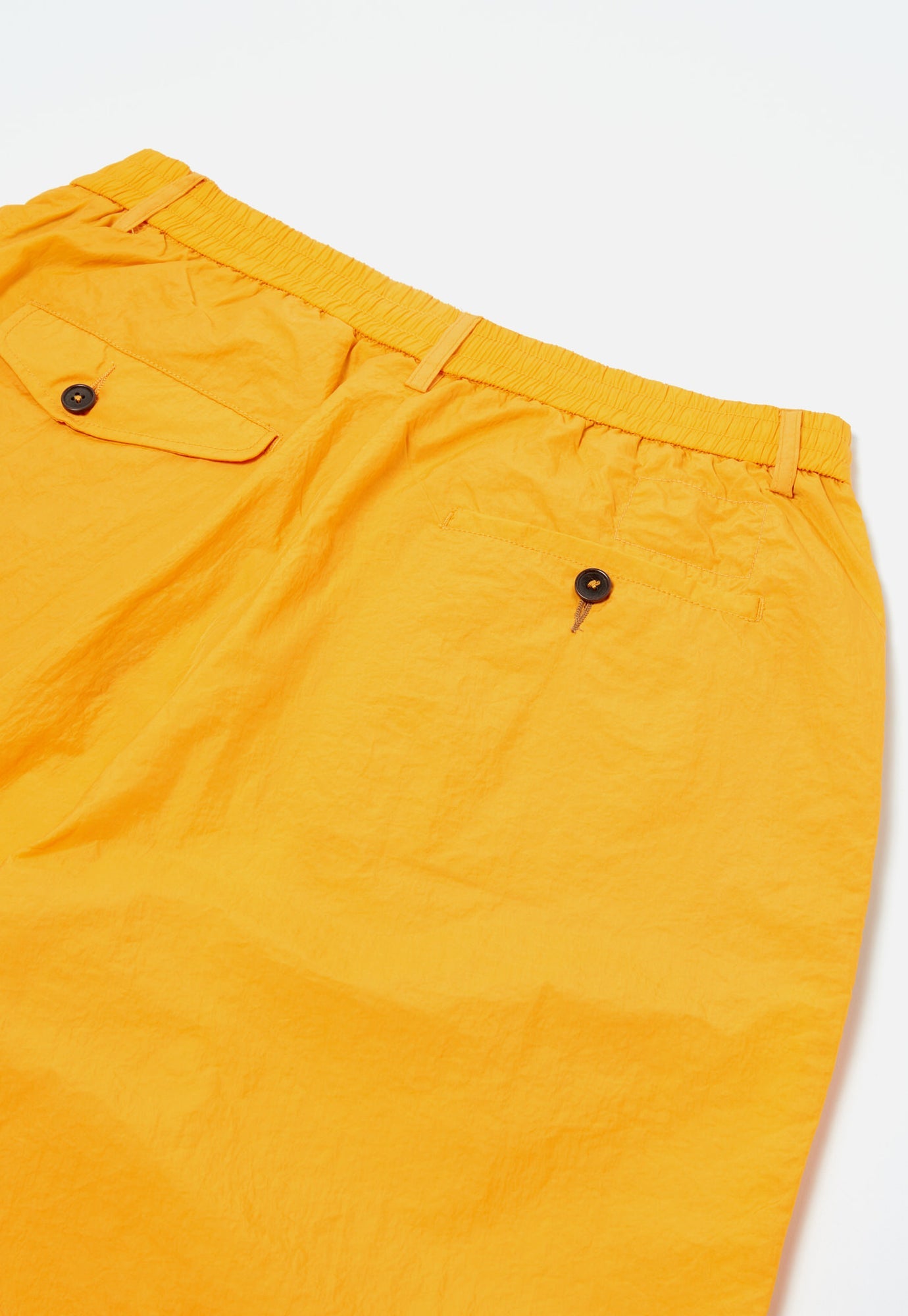 Universal Works Pleated Track Short In Orange Recycled Nylon Tech